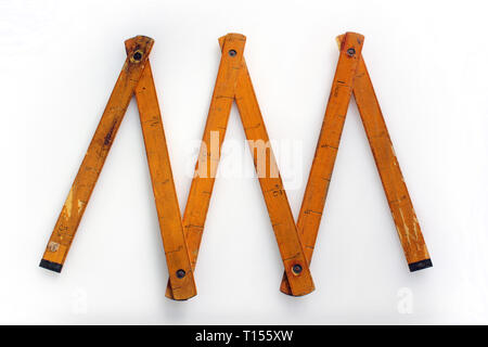 Vintage wooden folding ruler isolated on a white background.isolated on white background, close-up Stock Photo
