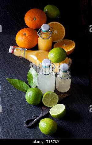 Freshly squeezed lime and orange juice in a swing top bottles Stock Photo