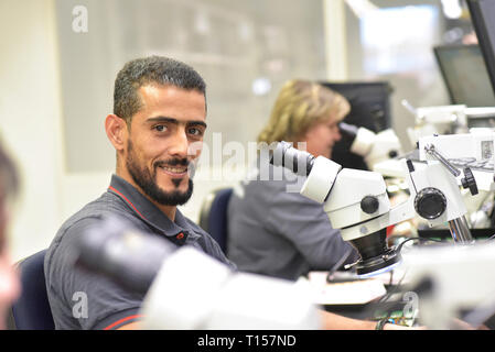 Portrait of smiling man working on quality control in the manufacturing of circuit boards for the electronics industry Stock Photo