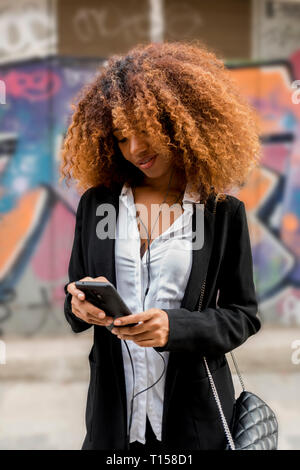 Young woman using smartphone Stock Photo