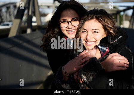 Portrait of happy friends hugging each other Stock Photo