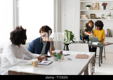 Young business people working together in coworking space Stock Photo