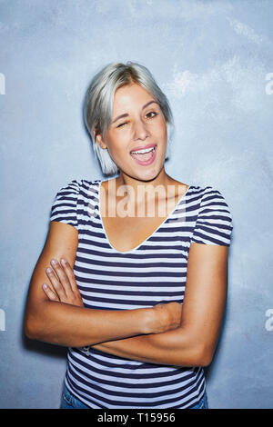 Cheaky young woman making funny faces Stock Photo