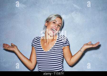 Cheaky young woman making funny faces Stock Photo