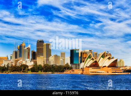 Major Sydney city CBD landmarks on waterfront of SYdney harbour around Circular quay and formal garden formed by high-rise office towers holding blue  Stock Photo