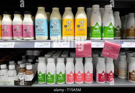 Bottles of various brands and flavour of kefir for sale on a refrigeration shelf in  Waitrose supermarket in London England UK Europe  KATHY DEWITT Stock Photo