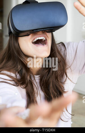 Young woman having fun using virtual reality headsets at home Stock Photo
