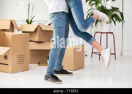 Close-up of happy ouple with cardboard boxes hugging in new home Stock Photo