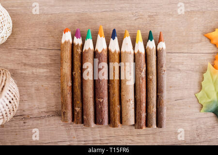 Wooden coloured pencils in a row Stock Photo