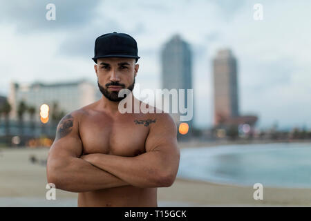 Portrait of barechested muscular man outdoors at dusk Stock Photo