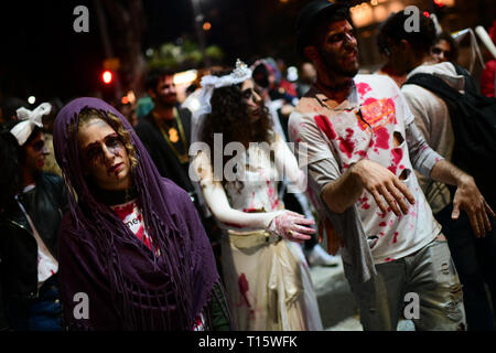 Tel Aviv, Israel. 23rd Mar, 2019. People wearing costumes take part in a zombie walk as part of the Purim celebrations in Tel Aviv, Israel, on March 23, 2019. Purim is a Jewish holiday that commemorates the deliverance of the Jewish people from Haman's plot during the reign of the ancient Persian Empire, according to the Biblical Book of Esther. Credit: JINI/Tomer Neuberg/Xinhua/Alamy Live News Stock Photo