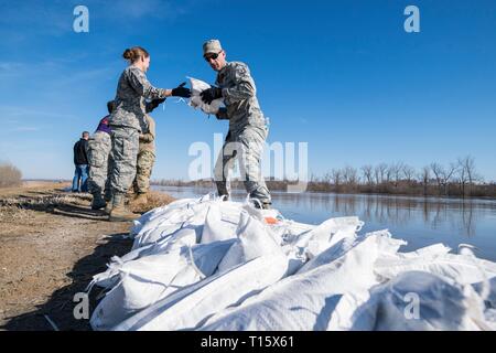 Missouri Air National Guard airmen stack sandbags to reinforce the levee that protects Rosecrans Memorial Airport March 22, 2019 in . Historic flooding caused by rapid melting of record snowfall sweep through rural communities in Nebraska, Iowa, Kansas and Missouri killing at least four people and causing widespread destruction. Stock Photo