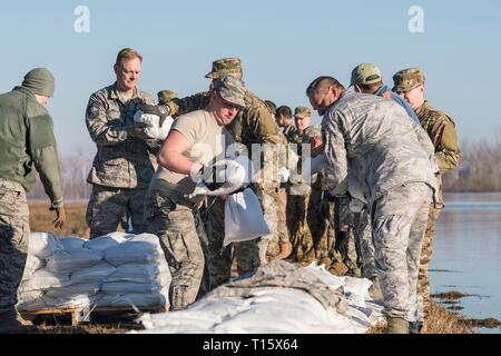 Missouri Air National Guard airmen stack sandbags to reinforce the levee that protects Rosecrans Memorial Airport March 22, 2019 in . Historic flooding caused by rapid melting of record snowfall sweep through rural communities in Nebraska, Iowa, Kansas and Missouri killing at least four people and causing widespread destruction. Stock Photo