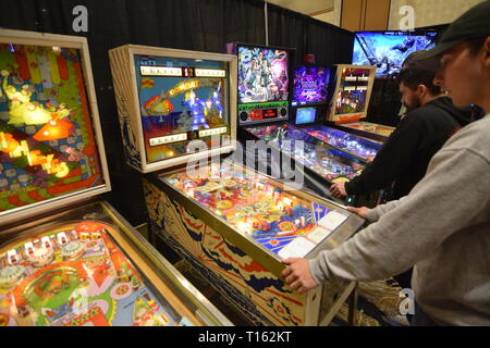 Frisco, USA. 23rd March, 2019.  Pinball enthusiast playing the Combat Pinball Machine at the Texas Pinball Festival at the Embassy Suites Dallas – Frisco Hotel and Convention Center. Credit: Mariana Fernandez/Alamy Live News Stock Photo