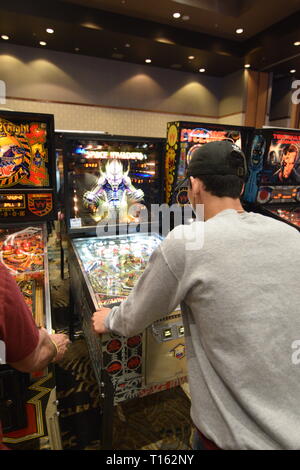 Frisco, USA. 23rd March, 2019.  Pinball enthusiast playing the Space Invaders pinball machine at the Texas Pinball Festival at the Embassy Suites Dallas – Frisco Hotel and Convention Center. Credit: Mariana Fernandez/Alamy Live News Stock Photo