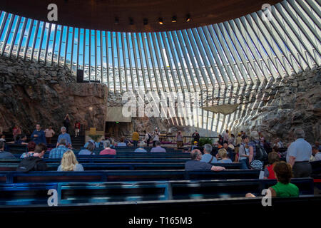 Interior view of the partially underground, rock-carved Temppeliaukio church in Helsinki, Finland. The Lutheran church has a natural appearance. Stock Photo