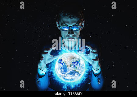 A man businessman holding hands over a blue glowing sphere in the form of planet earth. Elements furnished by NASA Stock Photo
