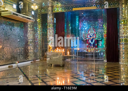 The unique Arulmigu Sri Rajakaliamman Glass Temple in Johor Bahru, Malaysia. The interior is completely covered in glass tiles. Glittery interior. Stock Photo