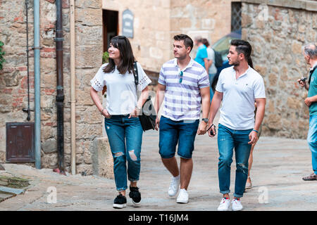 Monticchiello, Italy - August 26, 2018: Val D'Orcia countryside in Tuscany with alley in small town village with people tourists walking exploring sig Stock Photo