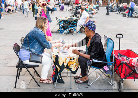 New Orleans, USA - April 22, 2018: Old town street in Louisiana town city by St Louis cathedral church and many people crowd on Jackson square with ta Stock Photo
