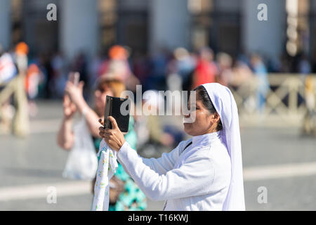 Rome, Italy - September 5, 2018: Closeup portrait of Christian catholic nun happy side profile in white habit veil smiling papal general audience taki Stock Photo