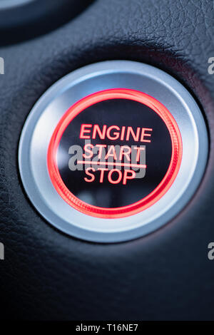 start stop car engine glowing red push button macro shot Stock Photo