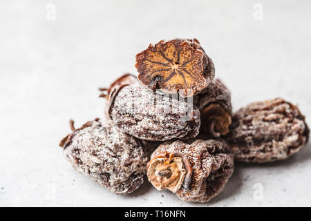 Dried sweet persimmon on a white background. Stock Photo