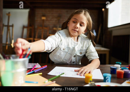 Cute Little Girl Drawing Stock Photo