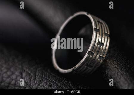 Male ring on a stand made of black leather with copy space Stock Photo
