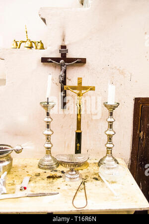 in the old parsonage there are old crucifixes, candles, incense and holy water, pronouns for holy mass Stock Photo