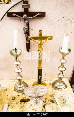 in the old parsonage there are old crucifixes, candles, incense and holy water, pronouns for holy mass Stock Photo