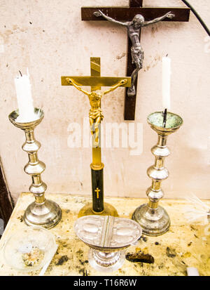 in the old parsonage there are old crucifixes, candles, incense and holy water, pronouns for holy mass Stock Photo