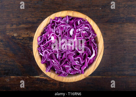 finely chopped purple cabbage in a plate on the table. view from above Stock Photo