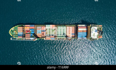 Close up drone shot top down aerial Indonesian container ship on Flores Sea at sunny day
