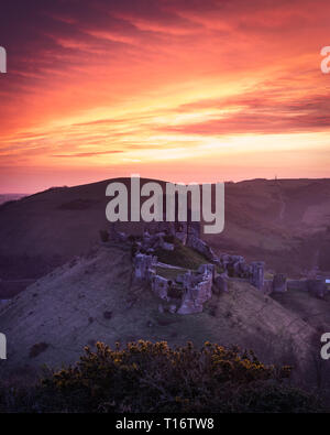 Red sunrise over Corfe castle, Dorset, UK Stock Photo