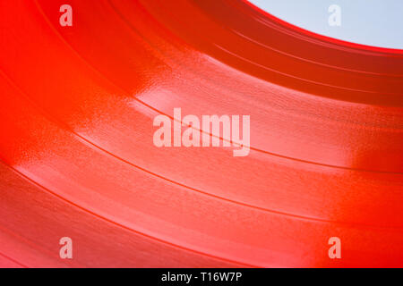 Close up of red vinyl surface. Red vinyl record texture background. Close up of vinyl LP record showing grooves Stock Photo