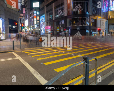 Central, Hong Kong - November 4, 2017: A photo taken with a slow shutter speed of pedestrians crossing at Queen's Road Central in Hong Kong. Stock Photo