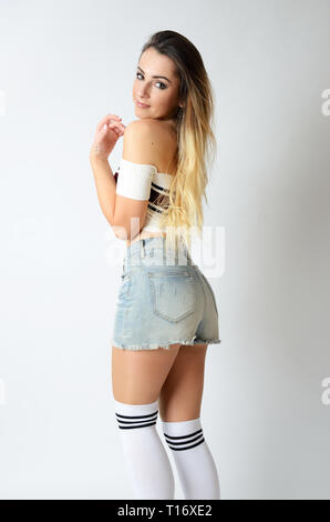 Fit girl from Poland with uncovered belly. Young female model with great  shape wearing white top, black shorts and socks Stock Photo - Alamy