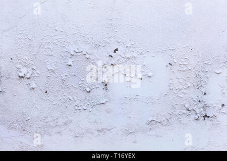 plain old aged white colored painted faded weathered peeled textured pattern on plastered concrete house wall surface background. Detailed backdrop, a Stock Photo