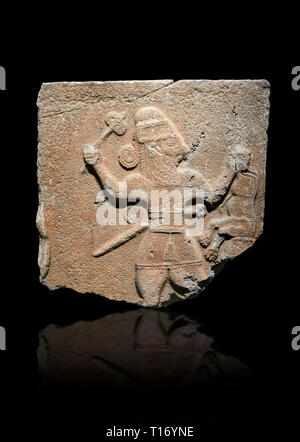 Hittite monumental relief sculpture of a man with an axe in one hand about to use it to kill a lion he is holding updide down in his other hand. Late  Stock Photo