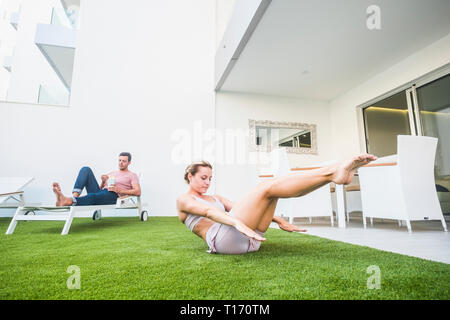 A young girl does Pilates exercises with a bed reformer, barrel machine  tool. Beautiful slim fitness trainer on the background of a reformer doing  var Stock Photo - Alamy