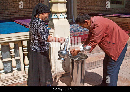 Washing hands before eating lunch, Kashgar, Xinjiang Autonomous Region, China. Stock Photo