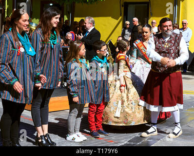 Falleras Mayores de Dénia and Courts of Honor in traditional costume attending street concert Stock Photo