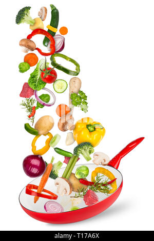 fresh ingredients falling flying into red frying pan creative cooking concept isolated on white background Stock Photo