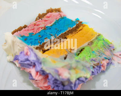 Multicolored layered cake slice closeup Stock Photo