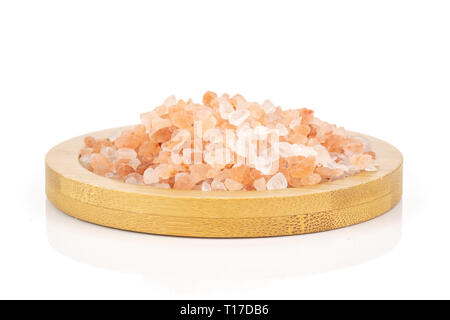 Lot of pieces of pink himalayan salt crystals on bamboo plate isolated on white background Stock Photo