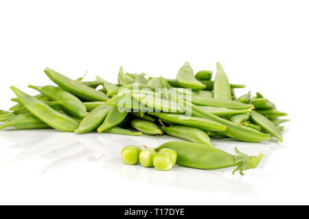 Lot of whole green sugar snap pea three peas one pod in a focus isolated on white background Stock Photo