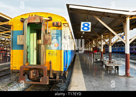 Hualamphong Central Train Station in Bangkok, Thailand - June 15 2011: Rear view of a colorful train standing at an empty platform number eight Stock Photo