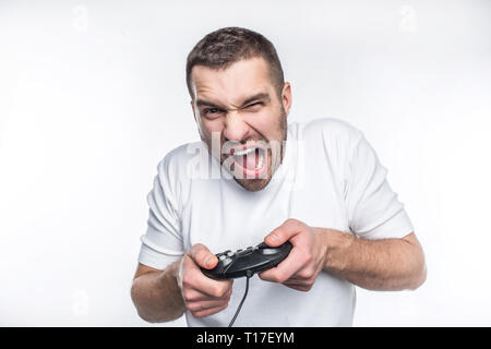 Intense game where only one man is playing. He is trying to win the game. He is screaming and yelling. Isolated on white background. Stock Photo