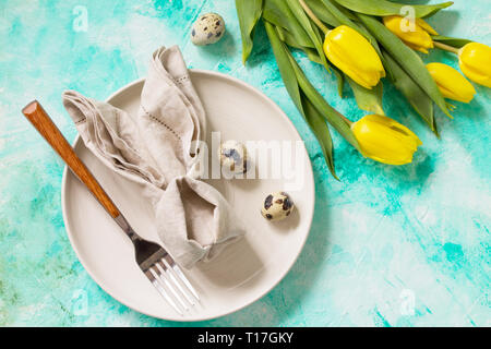 Holidays background. Easter table setting with tulips flowers. Stock Photo